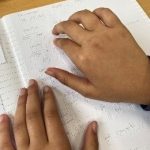 SEND student reading braile.