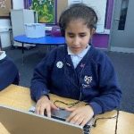 SEND Student working on a laptop.